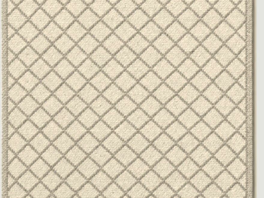 The rug in Oat: an undyed ground with a straw lattice.