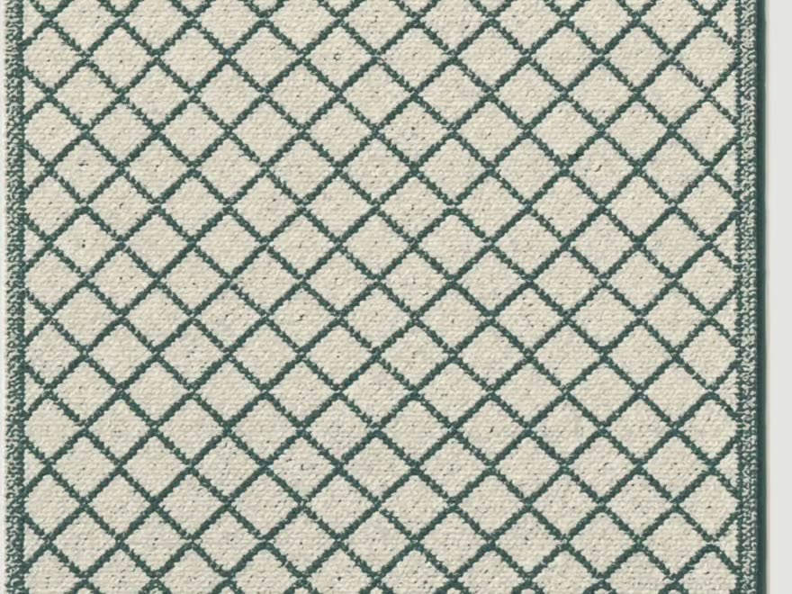 The rug in Woad: the same ground with a dark celadon lattice.
